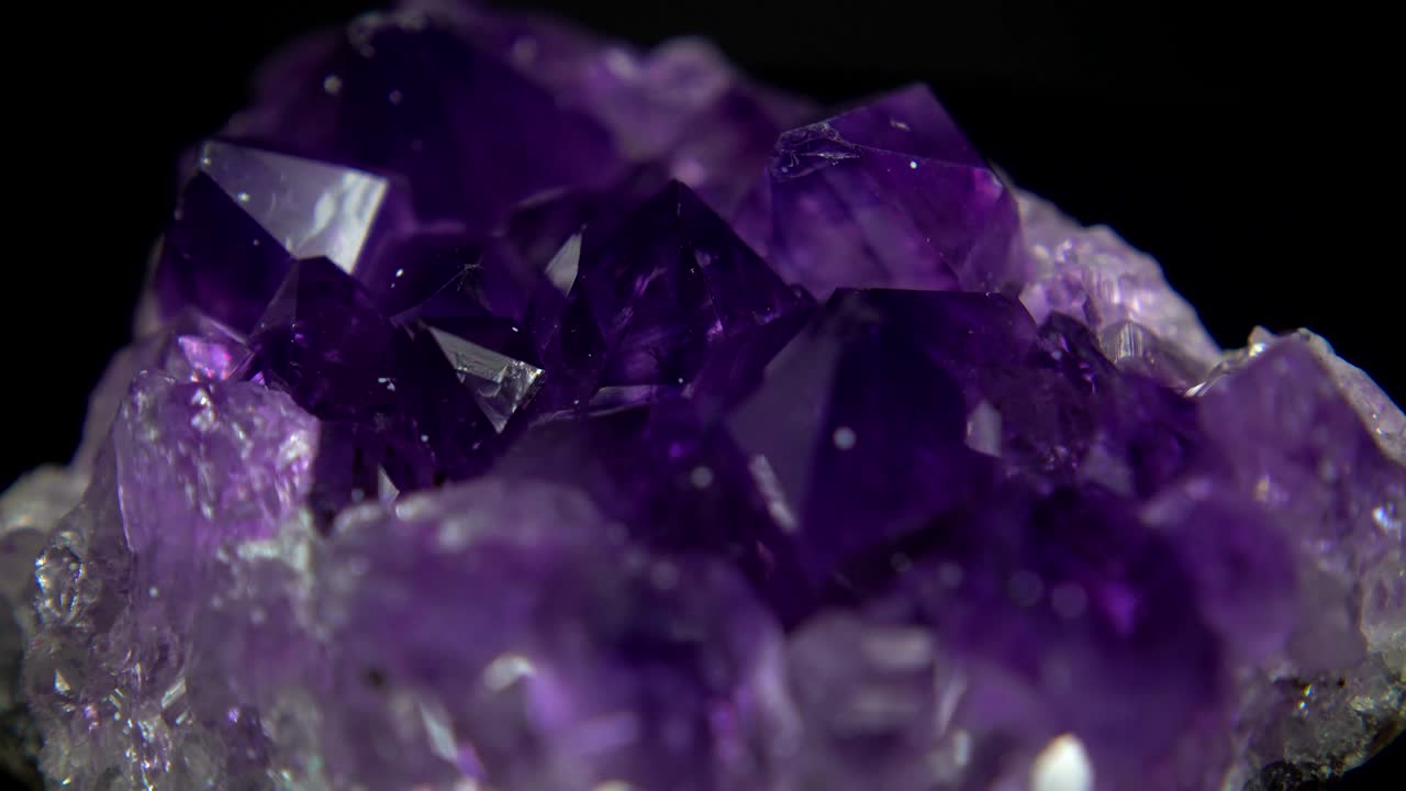 Seamlessly rotating a purple mineral (Amethyst) in front of black background