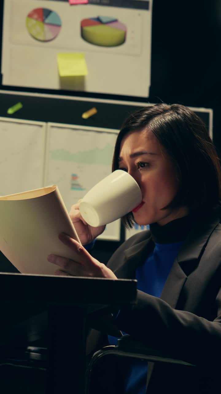 Vertical Video Private agent studying criminal files and archived folders in incident room
