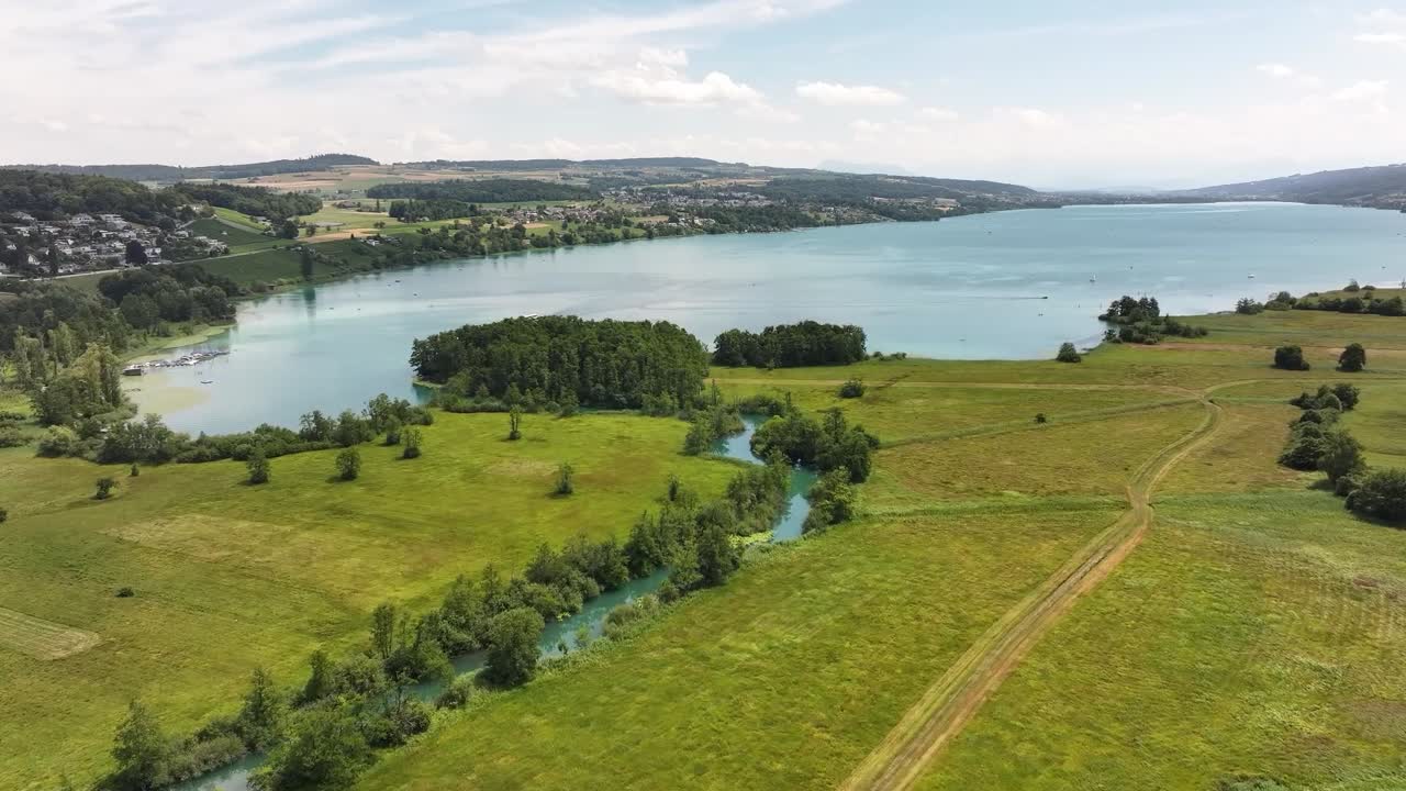 Hallwilersee lake at Aargau, Switzerland aerial drone view, green fields, trees and summer sky