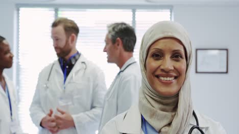 front view of middle-east female doctor standing with arms crossed in hospital