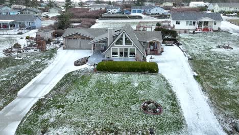 Snow-falling-on-an-a-frame-cabin-in-rural-America