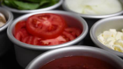 slowmo shot of tomato basil and mushrooms ingredients for homemade pizza