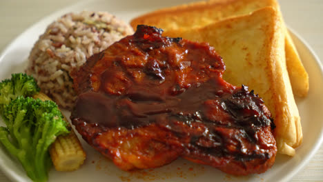 barbecue pork steak with rice berry on white plate