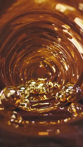 golden spheres swirling in a viscous amber vortex