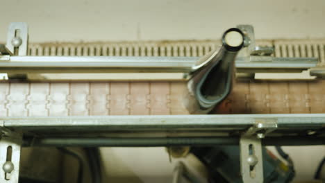 wine bottles closed with a cork stopper move along the conveyor belt view from above