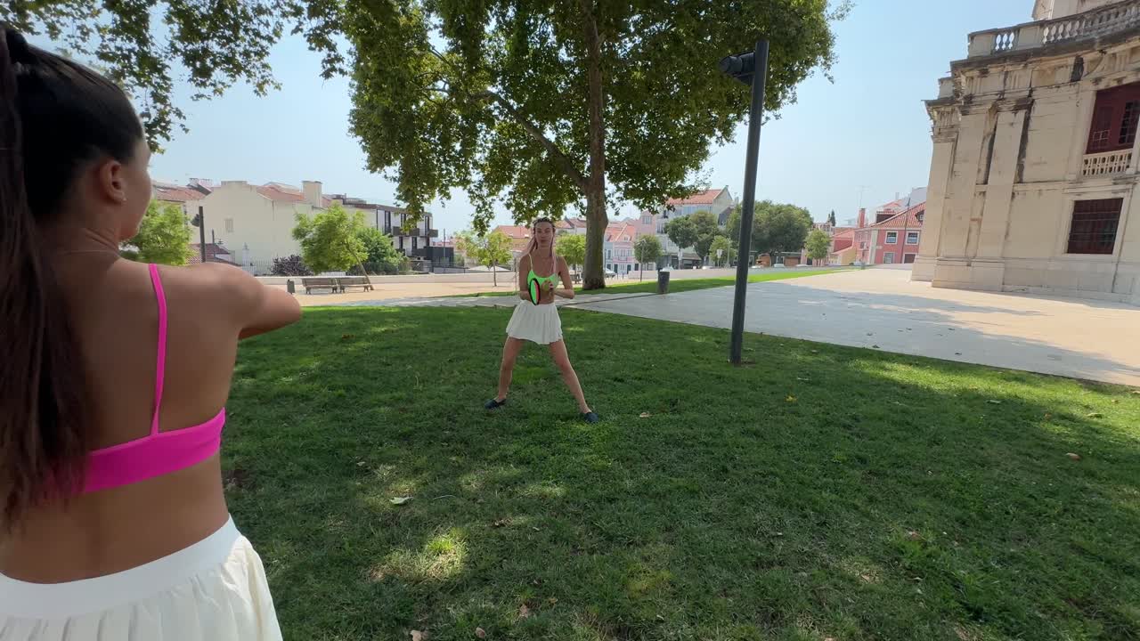Women exercising in a park with frisbees