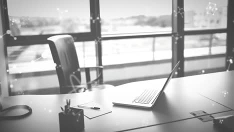 Animation-of-molecules-moving-over-laptop-on-desk