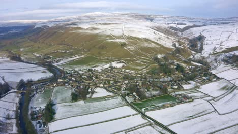 an aerial shot of kettlewell, covered in a light dusting of snow