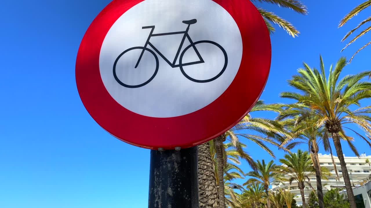 Spanish sign of corona virus to keep the distance with palm trees and blue sky in Marbella Spain, safety measures, tilting up