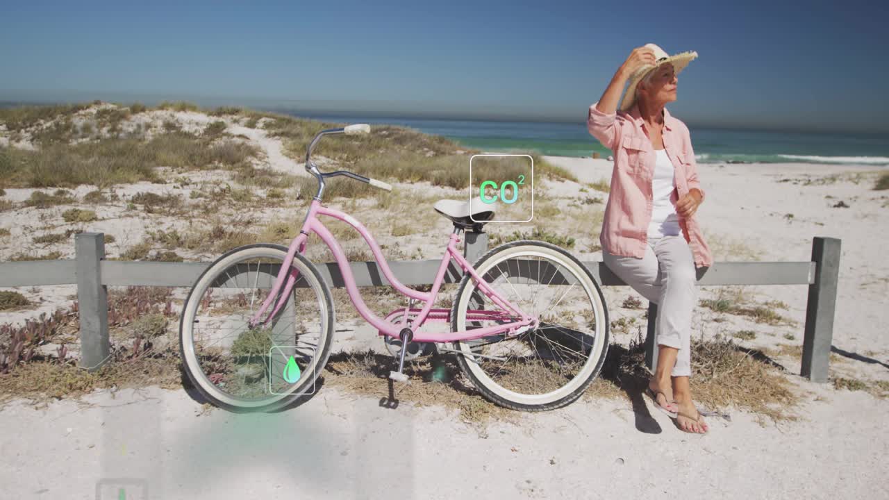 Senior woman adjusting posture on coast with tech data icons drifting, highlighting bicycle wheels