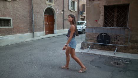 young woman walking through an italian alley