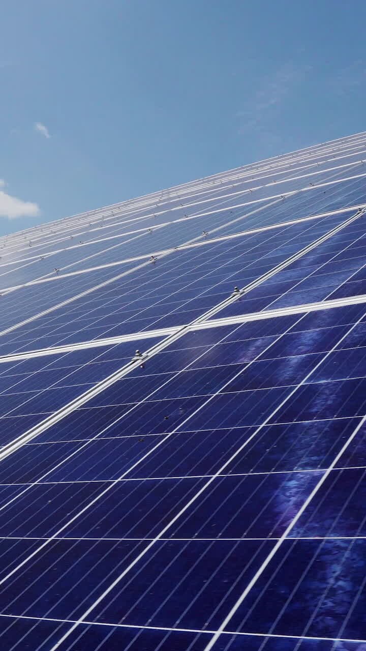 Photovoltaic solar panels at a power plant. Alternative energy production on the roof of the house. Vertical video