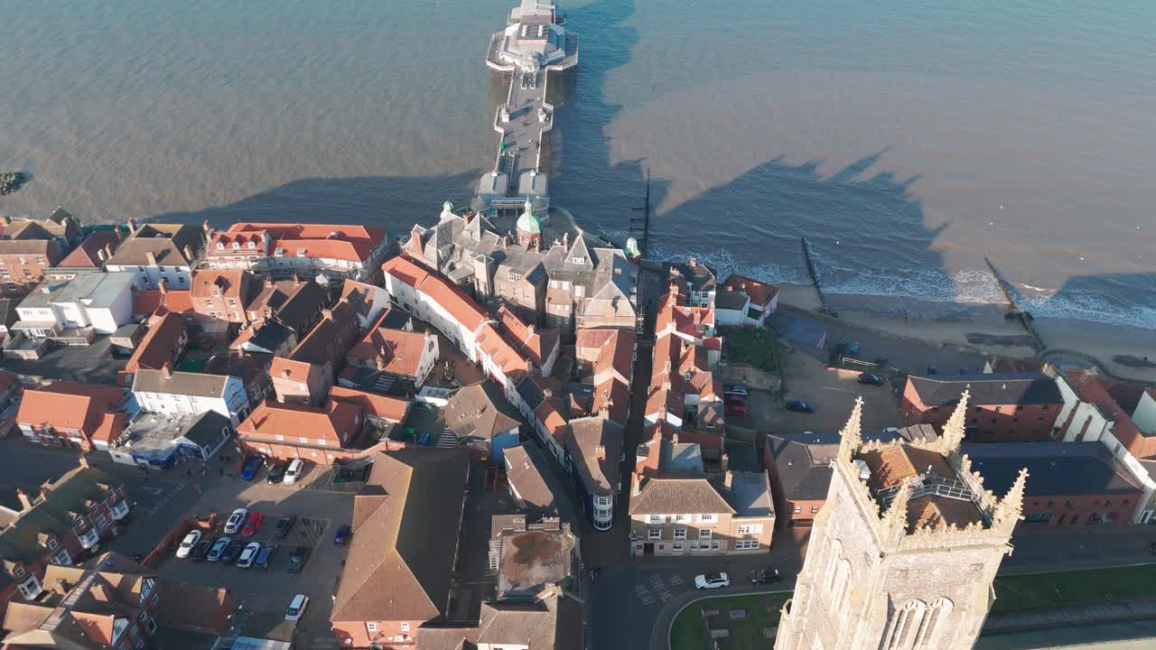 Cromer Pier and surrounding town buildings with a stunning aerial coastal view
