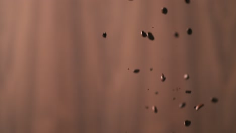 coffee beans falling in front of a backdrop in a studio