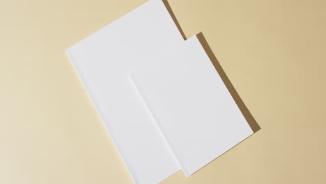 video of books with blank white pages and copy space on yellow background