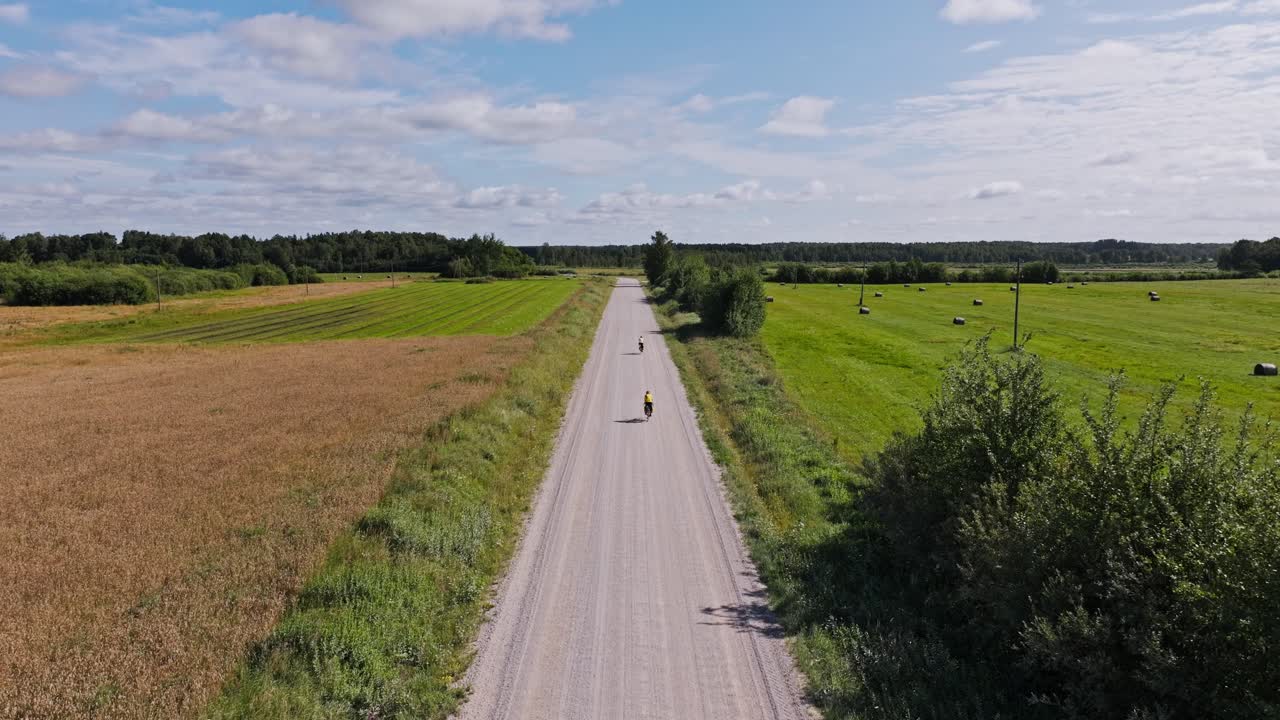 Two travelers biking through scenic northern countryside, freedom journey