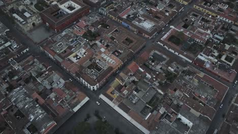 Drone-aerial-view-of-the-streets-and-houses-of-a-colonial-city,-Antigua-Guatemala