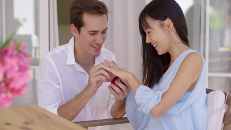 happy young woman accepting a wedding proposal