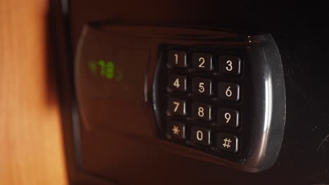 finger on a combination lock keypad