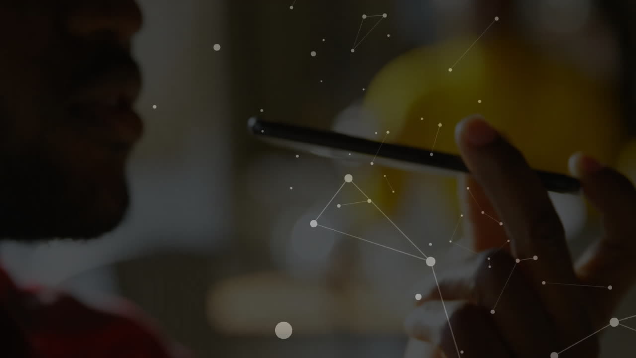 Animation of network of connections over african american businessman using smartphone