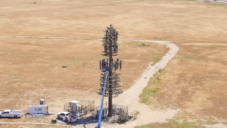 repairing or doing maintenance on a 5g cellular tower - orbiting aerial parallax