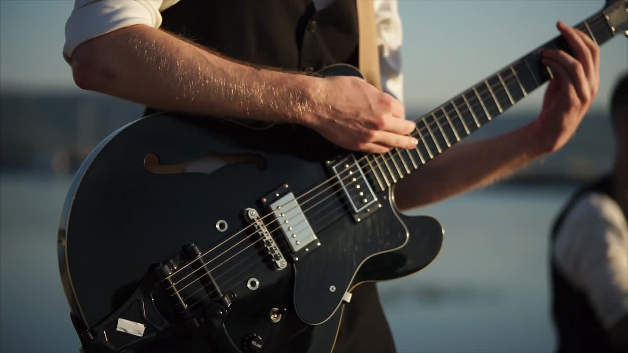 Man playing guitar outdoors
