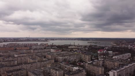 Aerial-Footage-Of-Grey-Buildings-Surrounded-By-Water