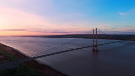 Humber-Bridge-at-golden-hour,-a-serene-passage-for-cars-below