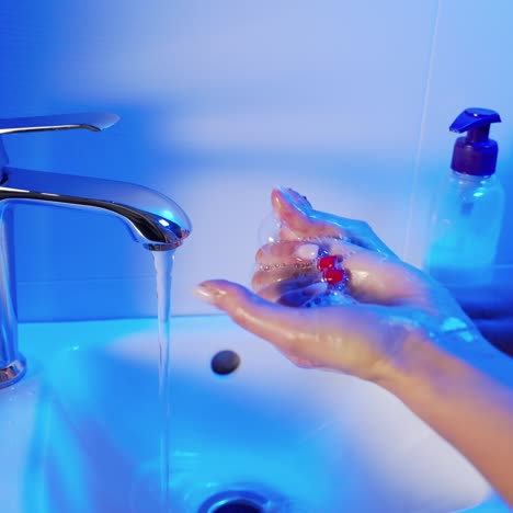young woman washing her hands in the bathroom. stop coronavirus. covid-19 prevention.