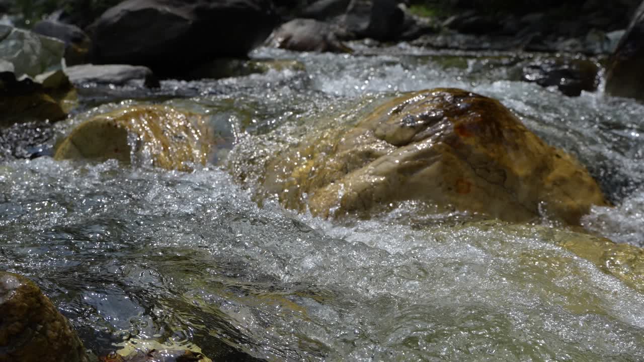 Water is flowing through a mountain torrential river.