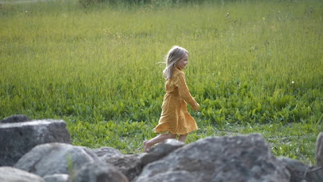 pure happiness and joy on young girls face as she runs on rural summer field, happy childhood