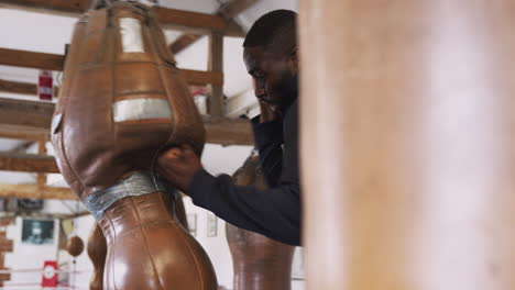 Male-Boxer-In-Gym-Training-With-Old-Fashioned-Punch-Bag