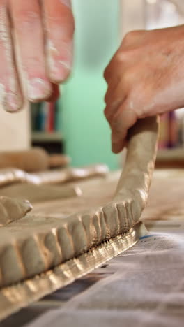 male potter molding clay
