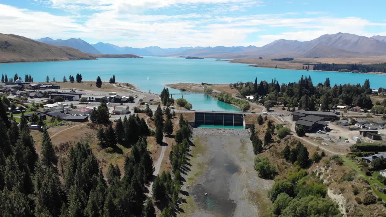 Drone Aerial View of Lake Tekapo Village, Dam and River Watercourse, New Zealand