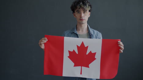 man holding canadian flag