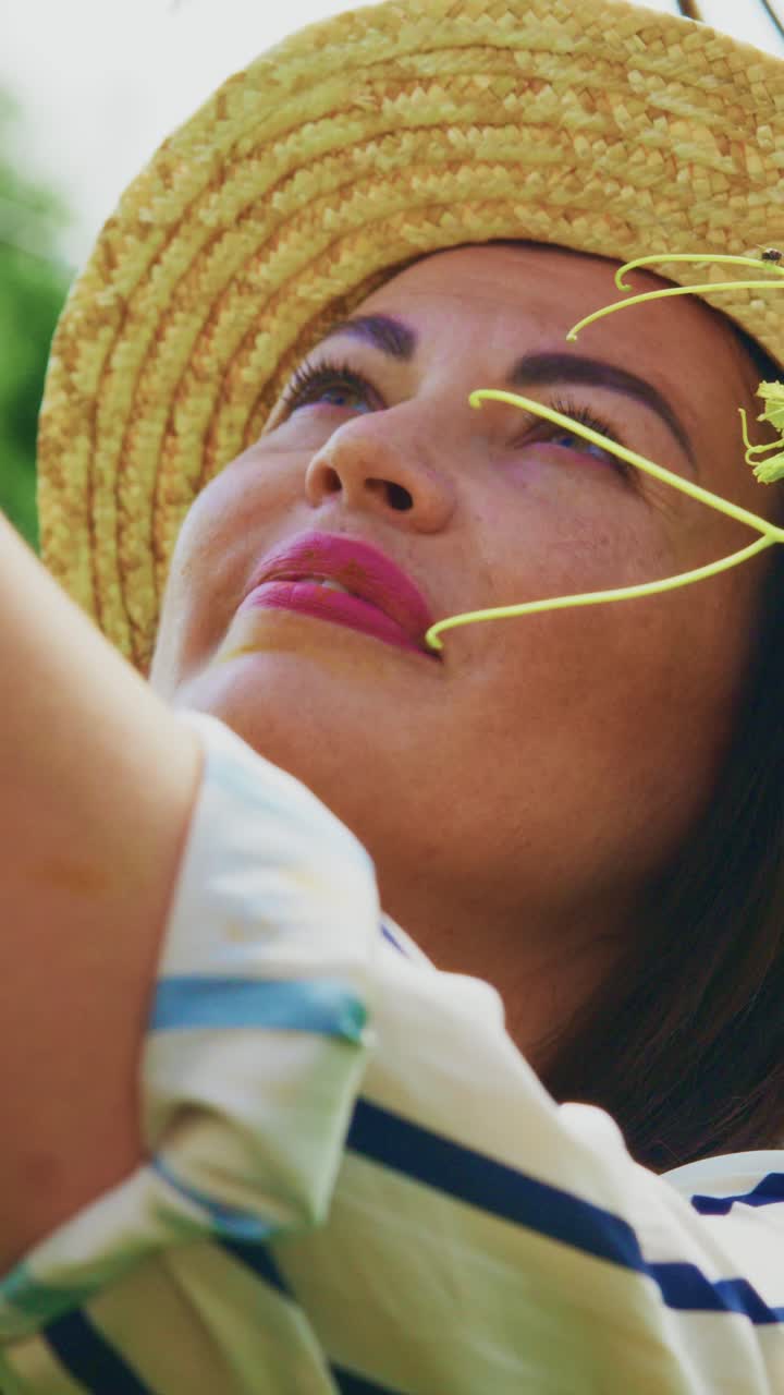 A Joyful Woman in a Straw Hat Enjoying Nature and Gardening, Surrounded by Greenery and Intricate Plant Life, Capturing the Essence of Growth and Sustainability