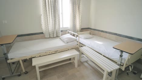 empty hospital beds in a ward of hospital with sulight entering in pakistan.