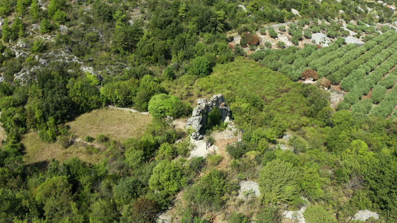 Aerial Circular Pan of Landmark Koloc Rock Arch on Brač Island, Croatia