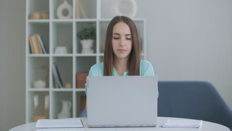 focused business woman entrepreneur typing on laptop doing research. young female professional using computer sitting at home office desk. busy worker freelancer working on modern tech notebook device