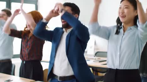 exciting team celebration: a diverse group of colleagues sharing joyful moments in a modern office space, engaging in fun activities and building strong connections together