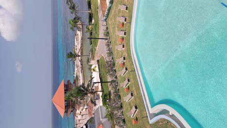 Vertical-View-Of-Swimming-Pool-And-Sun-Loungers-In-Hilton-Garden-Inn-Hotel-In-Dominican-Republic