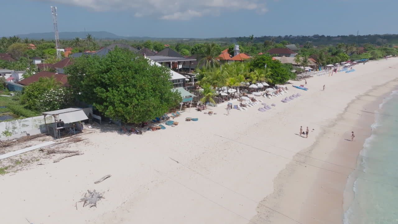 Drone clip showing white sand beach and clear blue water in Nusa Lembongan, Indonesia, an ideal vacation destination