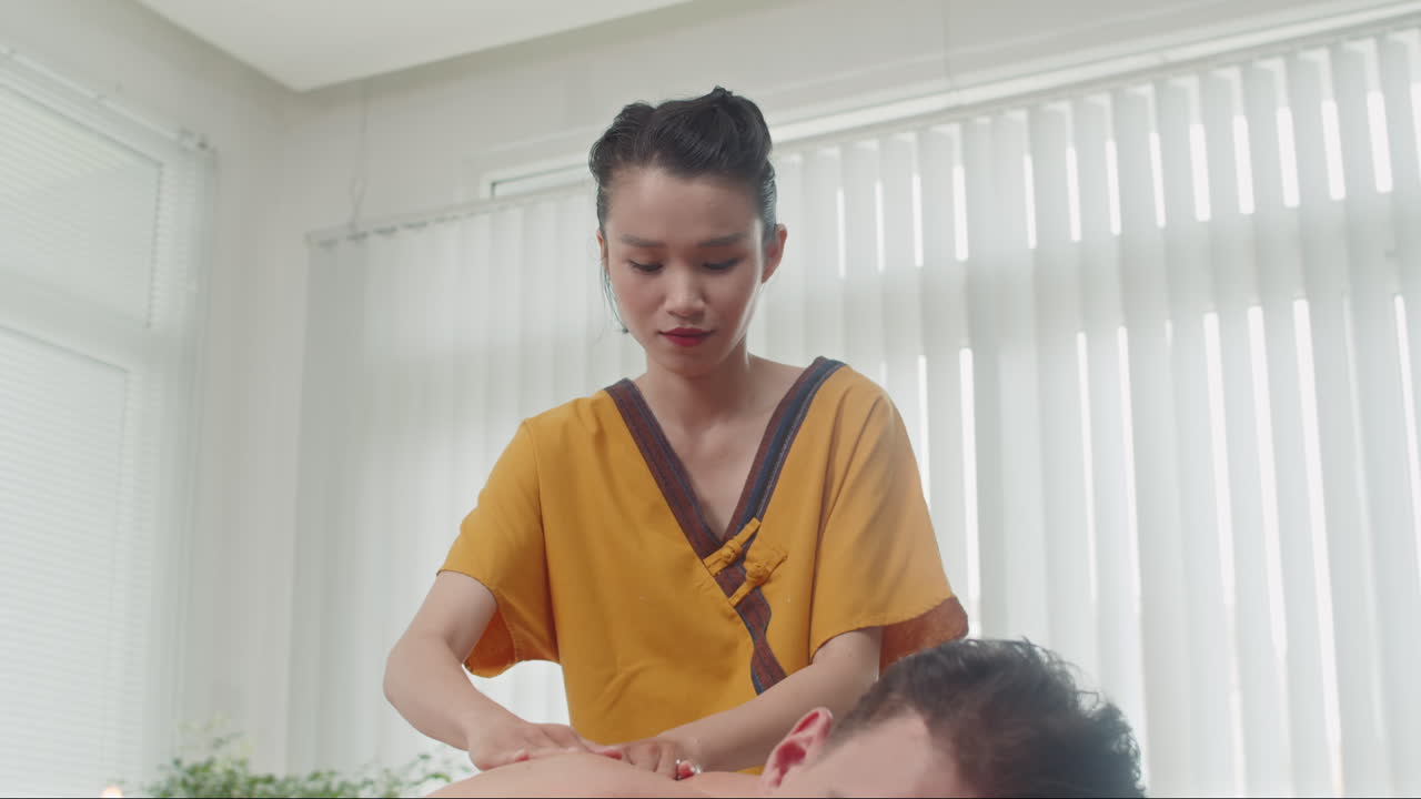 Man Getting Back Massage at Salon