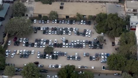 drop down view of massive parking lot full of cars in karachi, pakistan