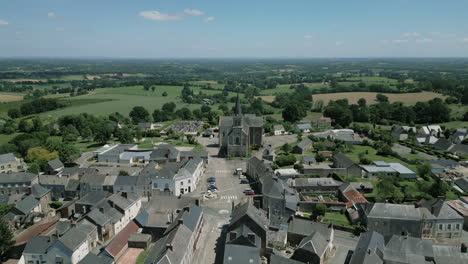 saint corneille and saint cyprien church in la baconnière municipality and countryside in background, mayenne in france