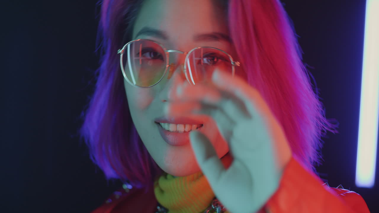 Stylish Woman with Pink and Purple Hair in Neon Lighting