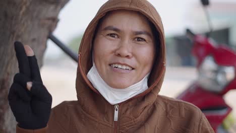 woman wearing a hoodie and mask outdoors