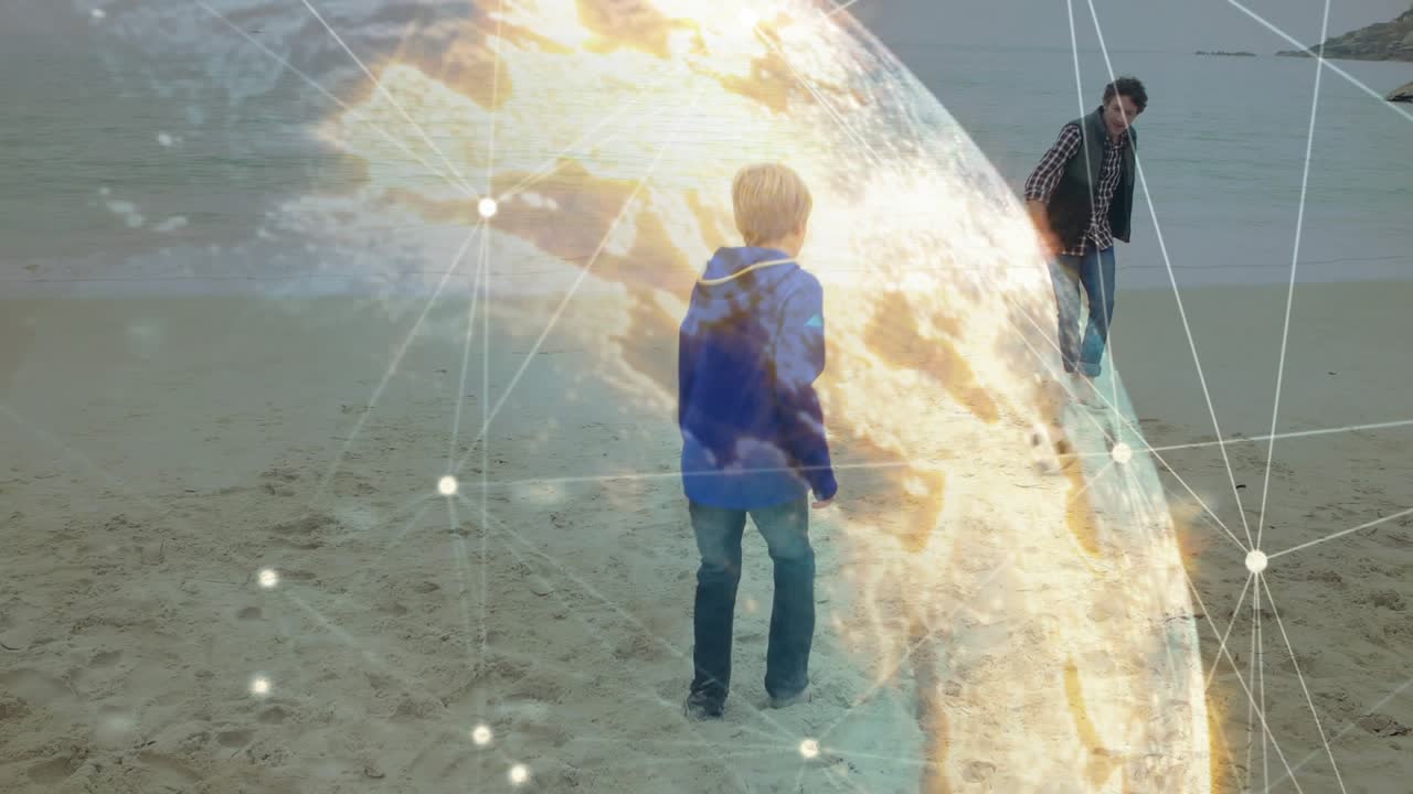 Boy approaching man on beach, kicking soccer ball and practicing, globe overlay showing tech data