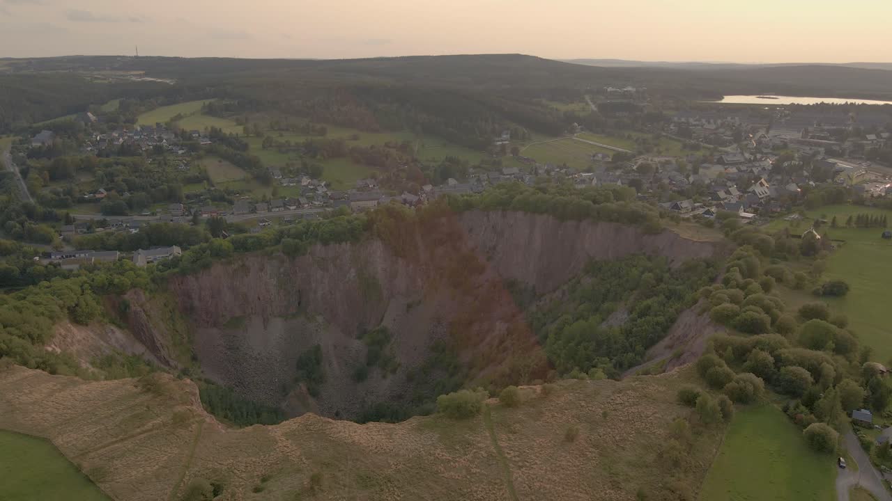 Panorama fly over of mining sinkhole at Altenberg, Saxony with drone