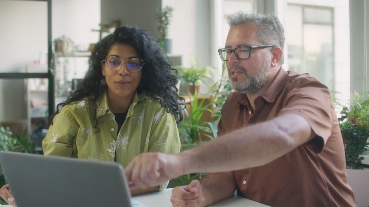 Diverse Colleagues Using Laptop at Work